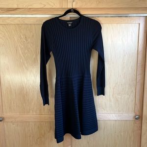 Club Monaco long sleeve navy blue knit dress with flare skirt.